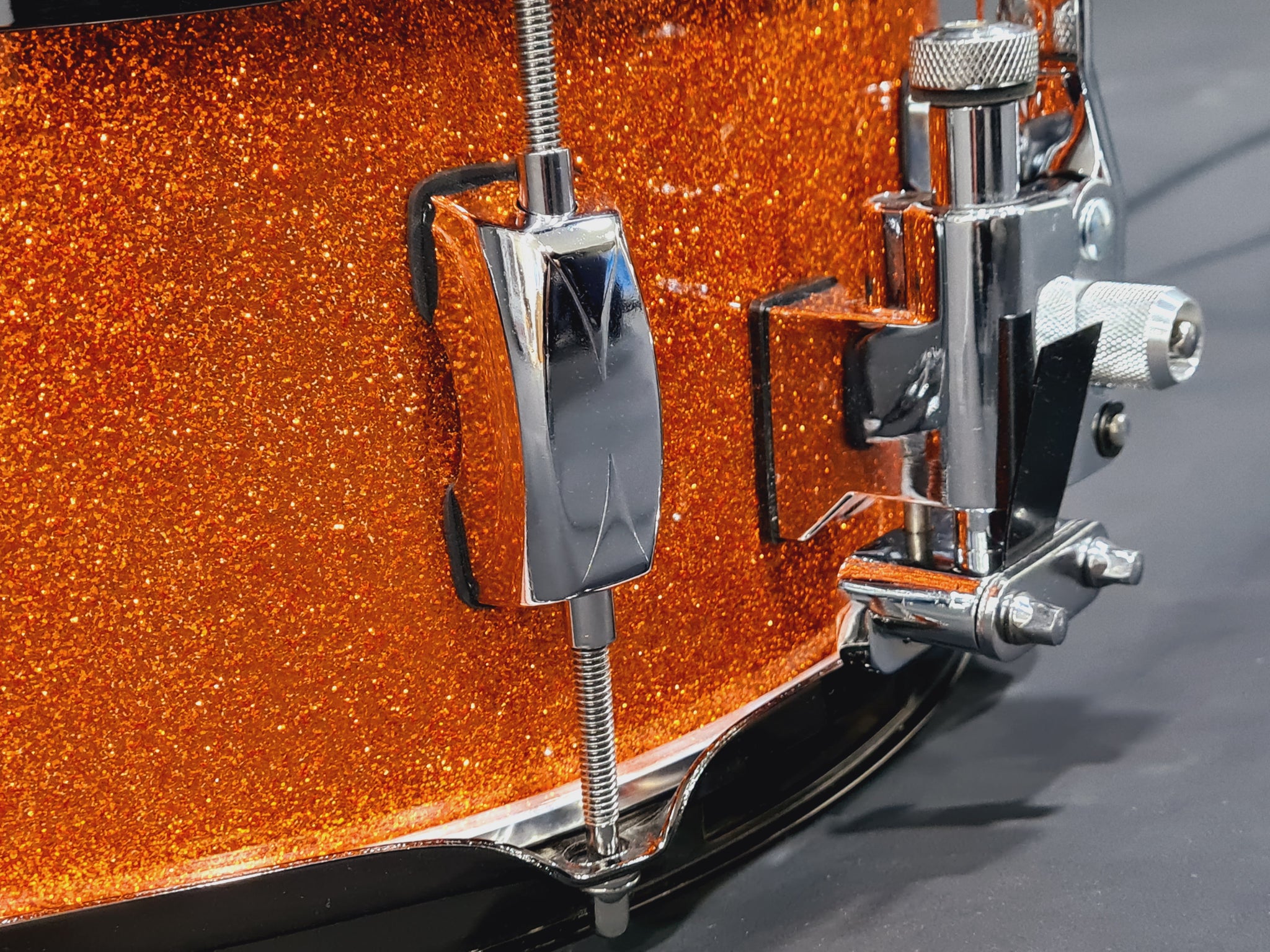 14x5.5" Liberty Drums Snare drum in a stunning orange sparkle lacquer